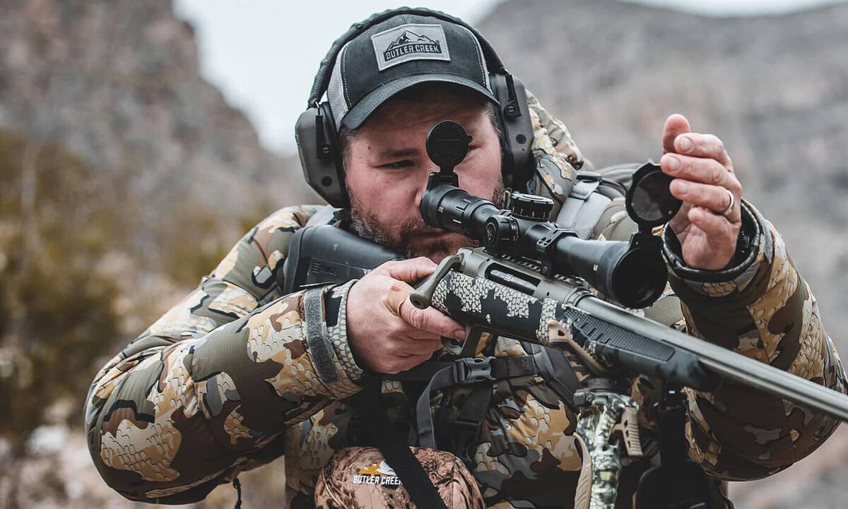 Man looking through scope 