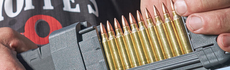 Shooter reloading a Magazine with a Magazine Loader