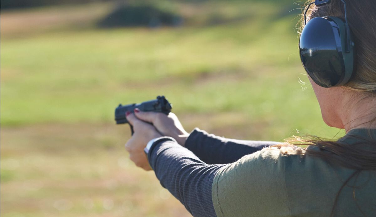 Woman shooting at target