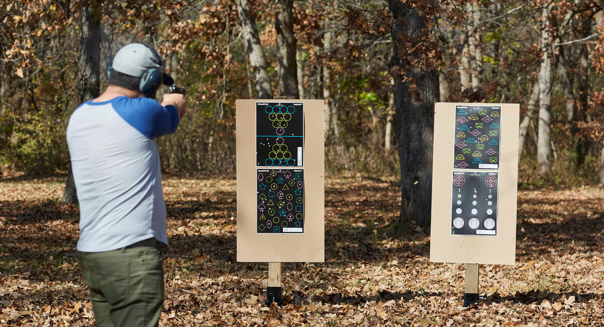 Man aiming rifle down range.