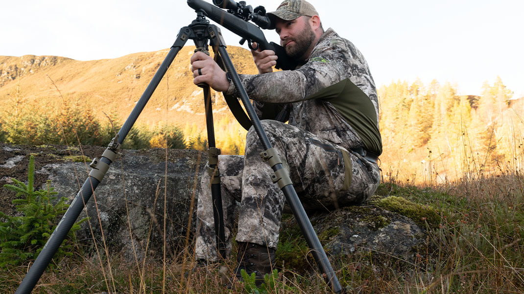 A Hunter Sitting with Apex Shooting Stick A Hunter Sitting with Apex Shooting Stick